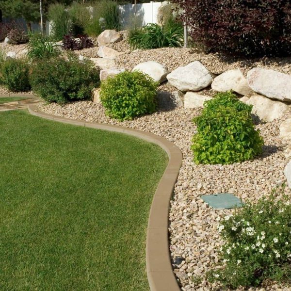 Custom backyard landscape design with curved stone pathway and green lawn installation