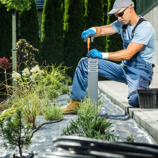 Professional landscaper installing lights as part of a residential landscape project