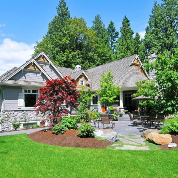 Custom landscape design featuring Japanese maple and decorative garden beds