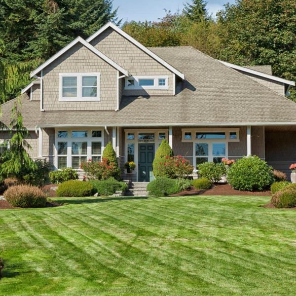 Residential landscape installation with manicured lawn and decorative garden borders