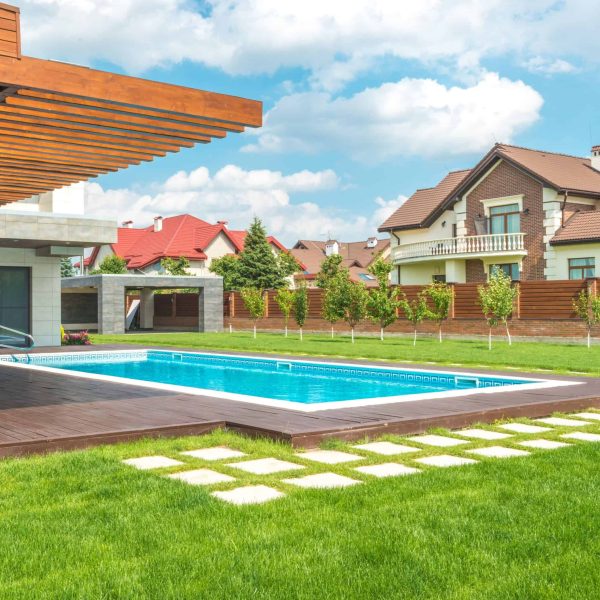 Professional residential landscape design with manicured lawn and garden plantings